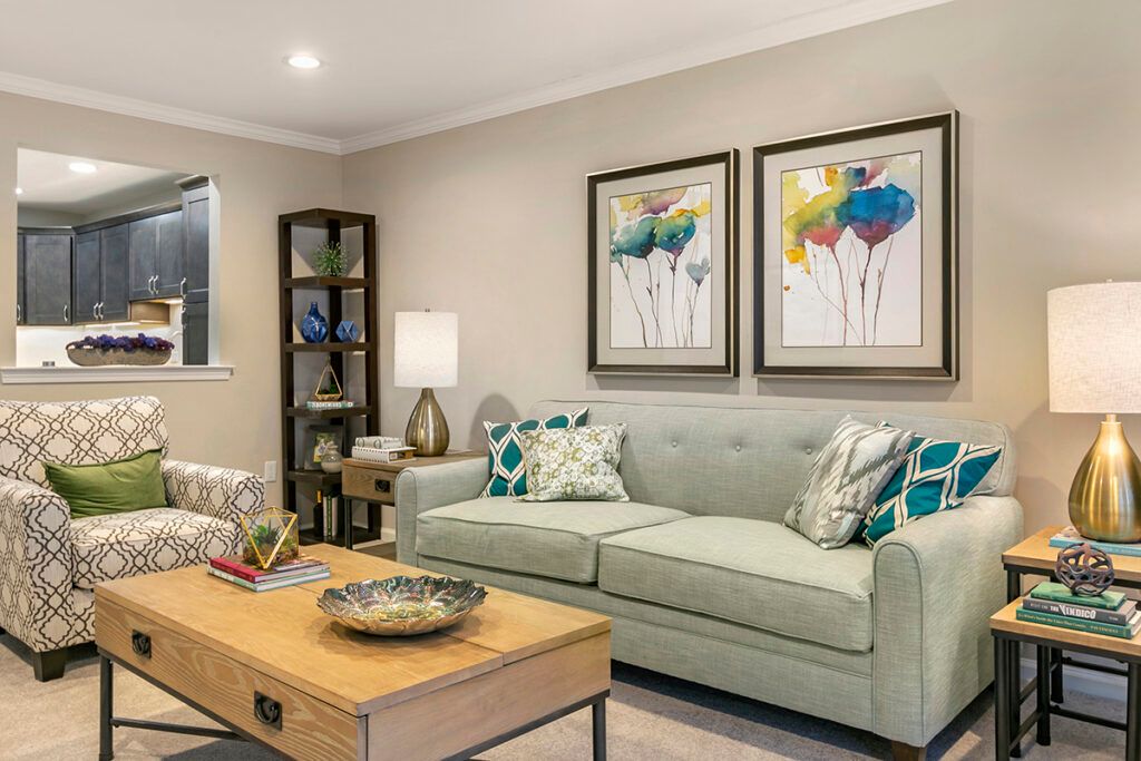 A modern living room with a comfortable sofa, colorful artwork, and stylish decor.