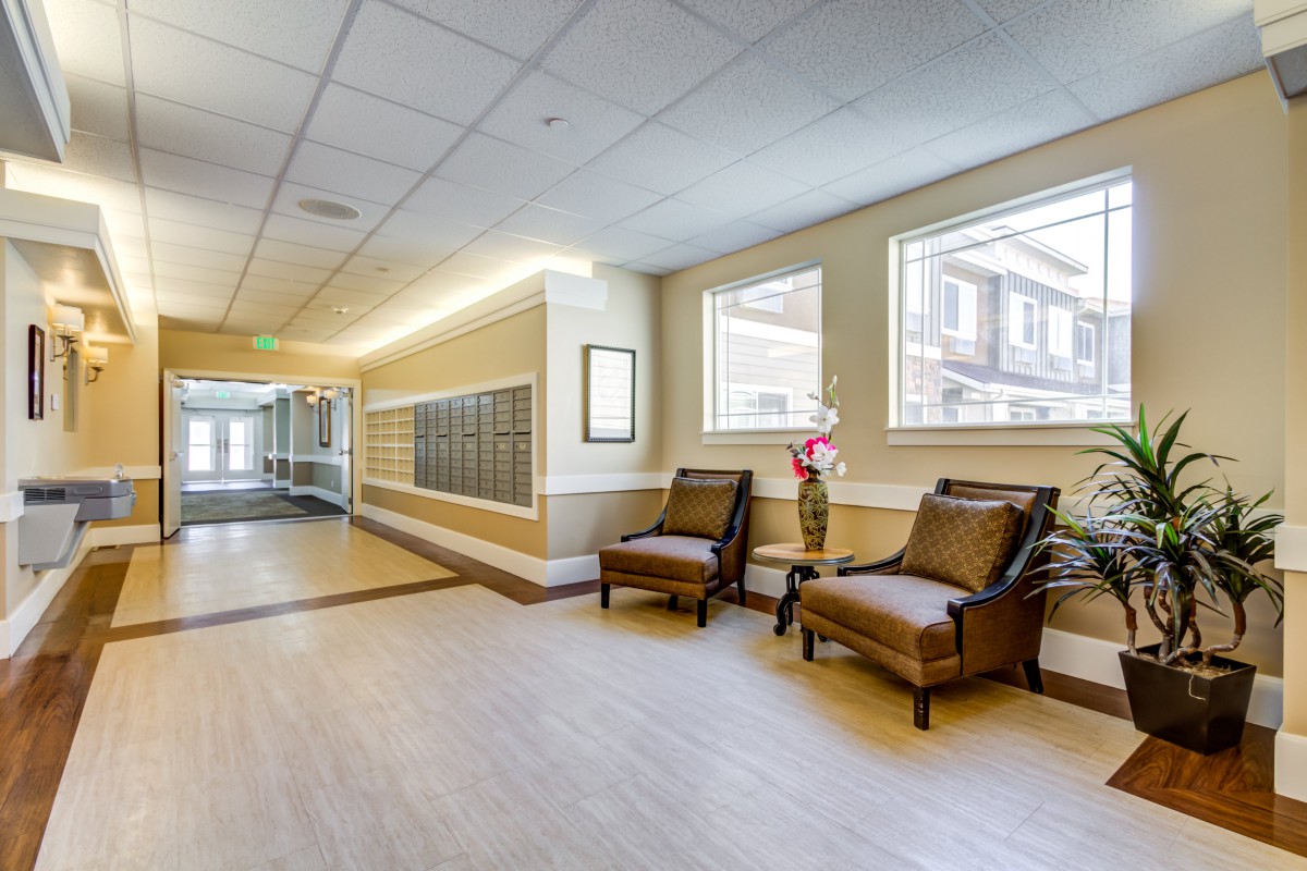 A well-lit modern hallway with comfortable seating and decorative touches.