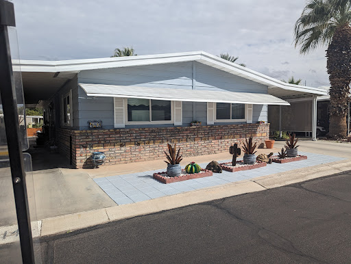 A charming residential house featuring a landscaped front yard with decorative cacti.