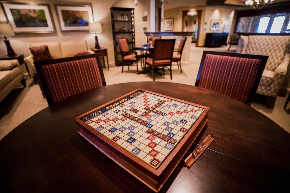 A cozy living room featuring a Scrabble board game set up on a wooden table, ready for play.