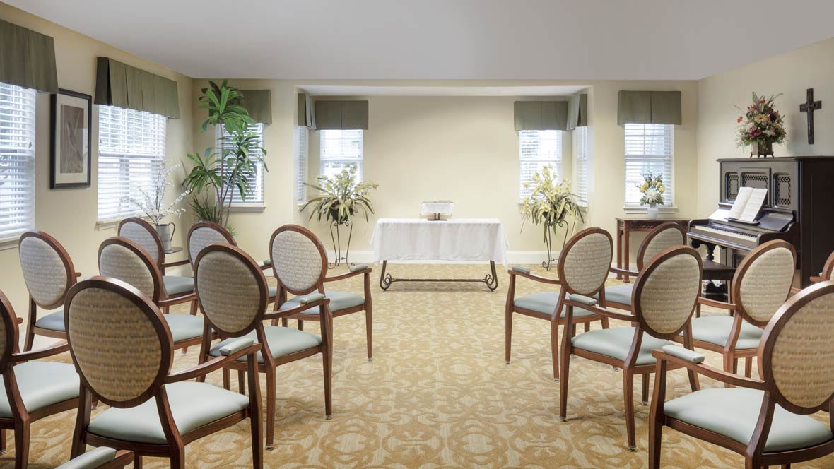 An elegantly arranged room with chairs set up for a small ceremony or event.