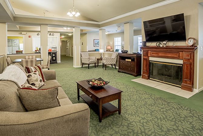 A cozy living room with a fireplace, television, and comfortable seating.