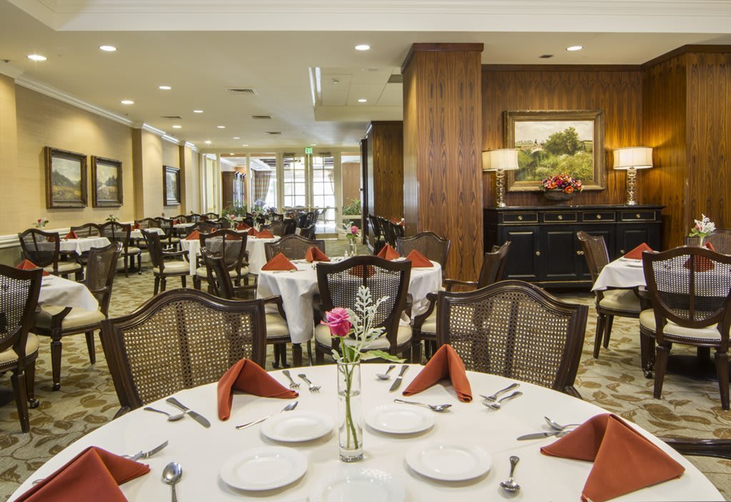 An elegant restaurant dining area with neatly arranged tables and chairs.