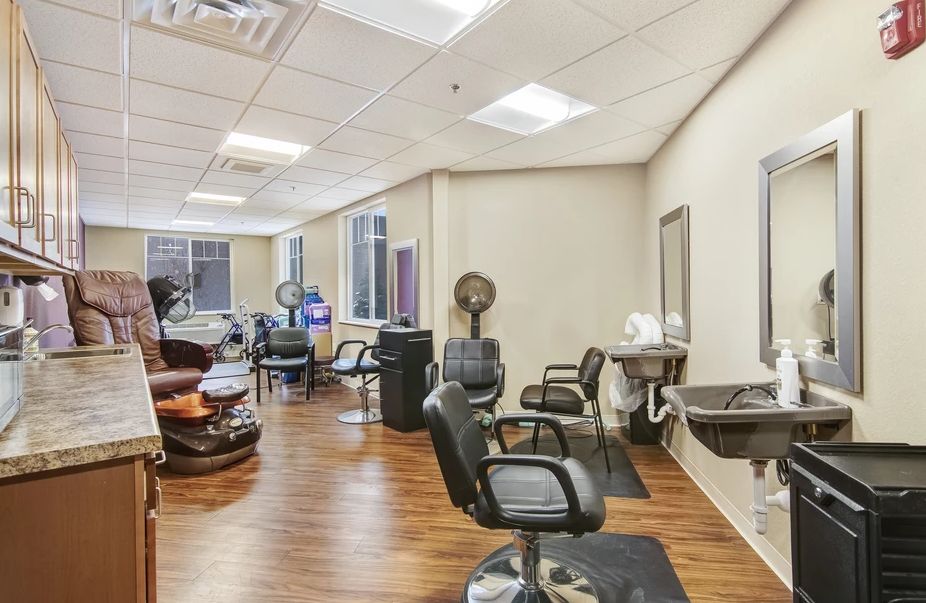 Interior of a modern hair salon with salon chairs and equipment.