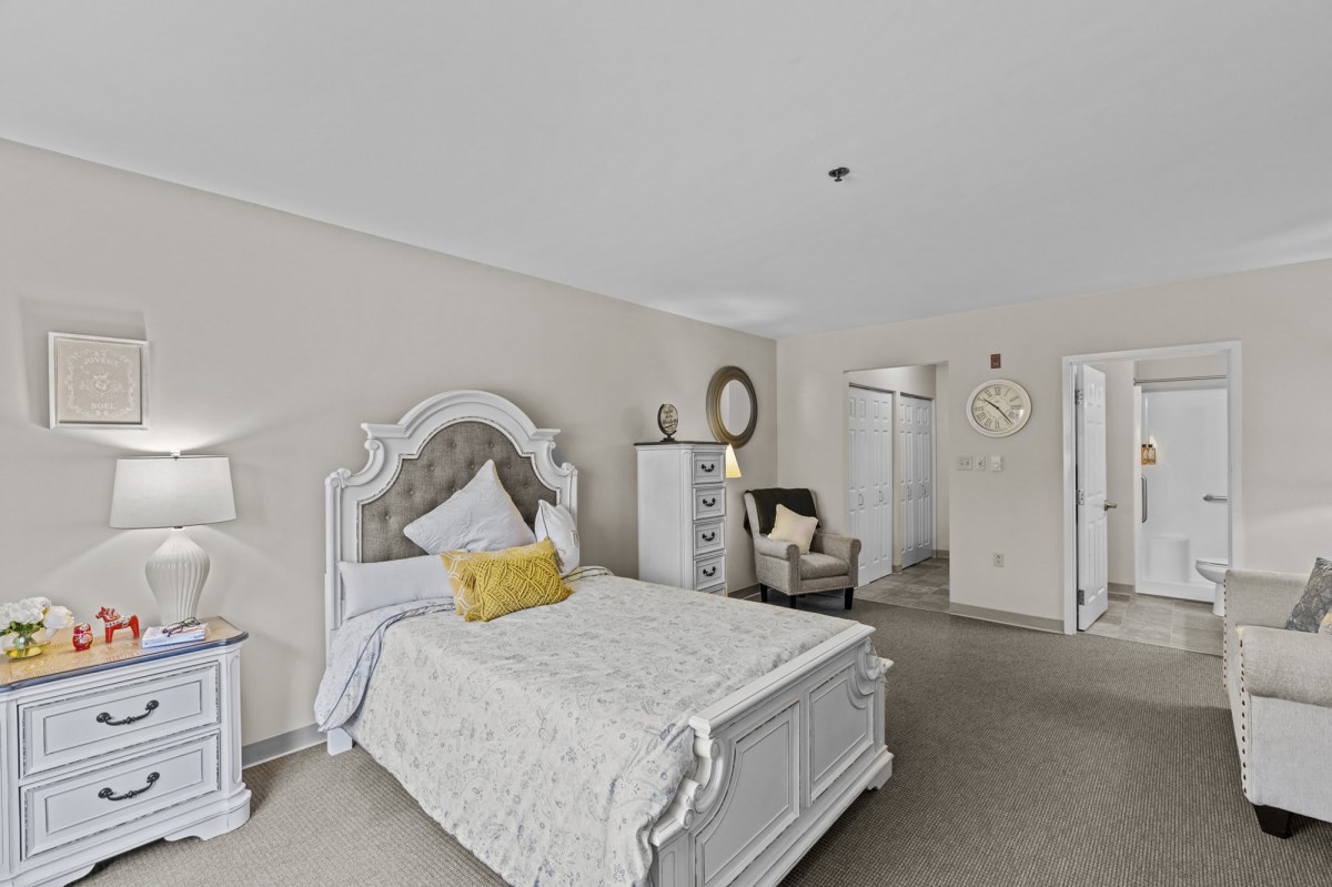 A cozy bedroom with elegant furniture and soft lighting.