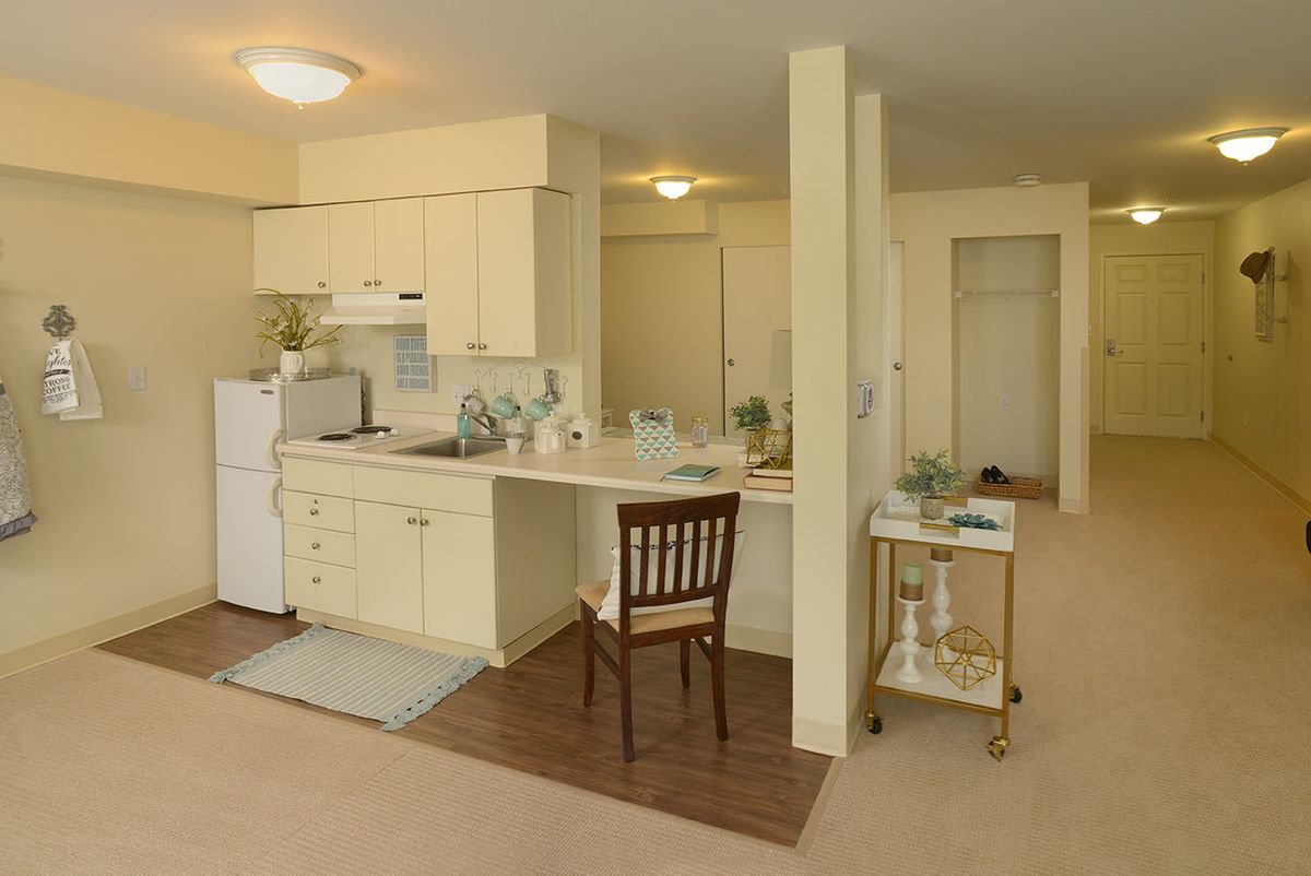 A cozy apartment kitchen with a small dining area and home decor accents.