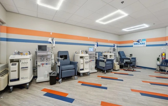 A modern dialysis clinic with multiple treatment chairs and machines.