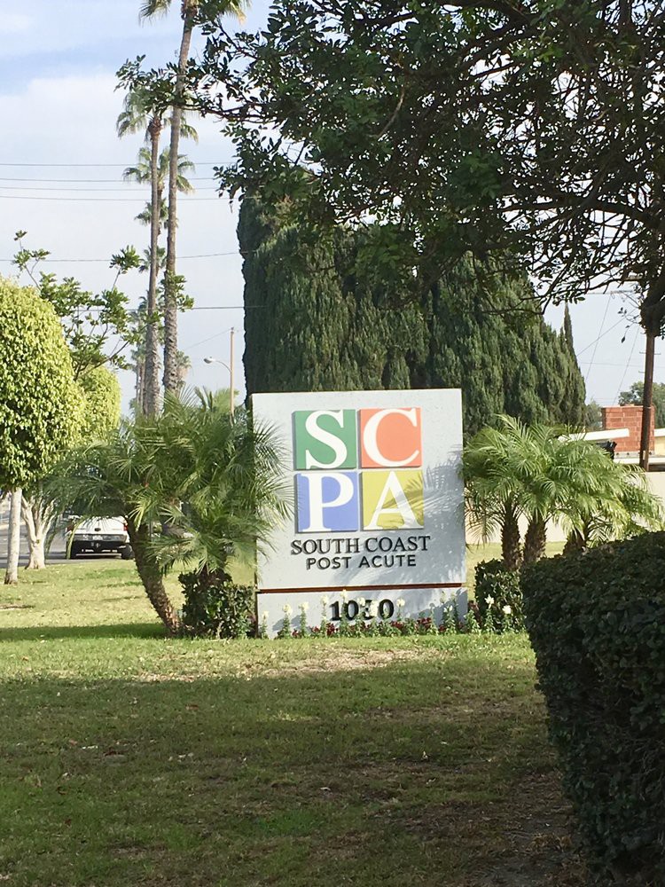 A sign for Southwest Performing Arts surrounded by greenery.
