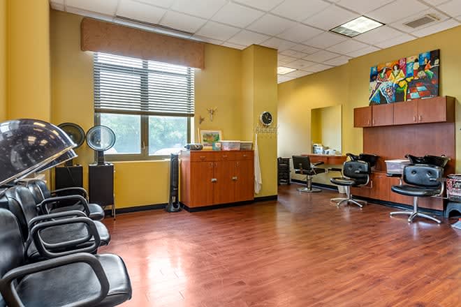 An inviting hair salon interior with a waiting area and styling stations.