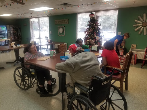 Residents engaging in an activity together in a care facility during the holiday season.