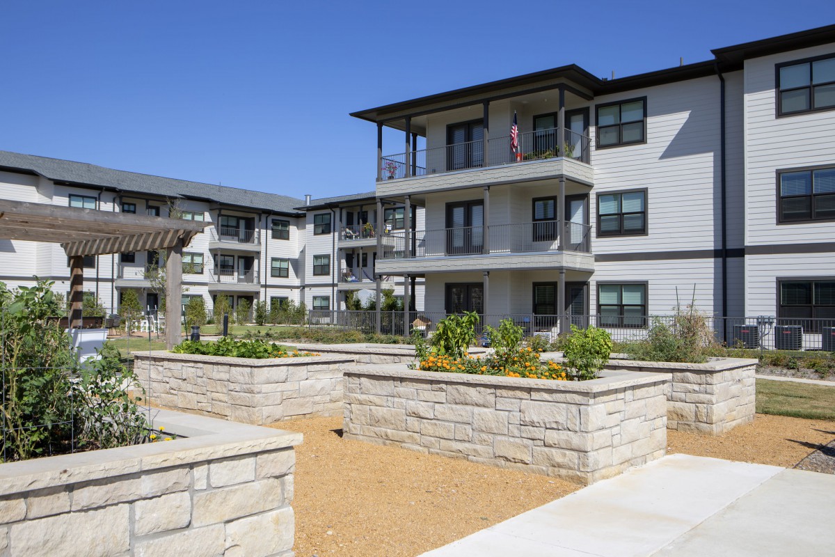 Modern apartment complex with landscaped outdoor area.