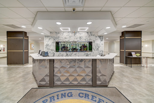 A modern hotel lobby featuring a stylish marble reception desk.