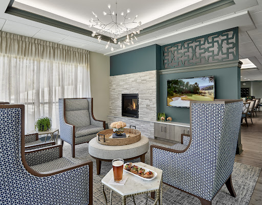 A modern and inviting living room featuring stylish furniture, a cozy fireplace, and elegant decor.