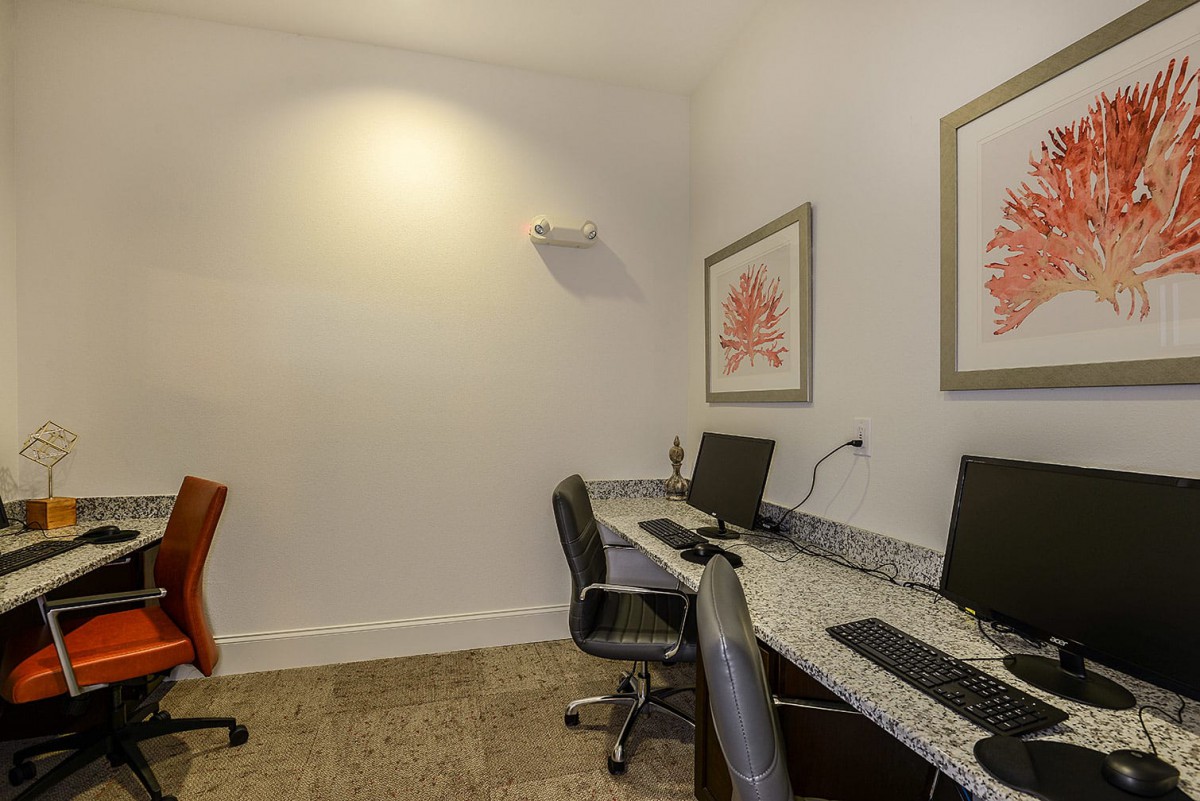 A small office space with two computer workstations and chairs.