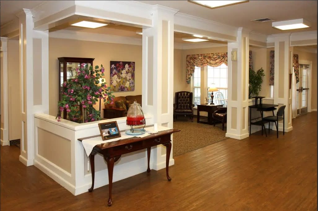 A well-furnished lobby with classic decor and wood flooring.
