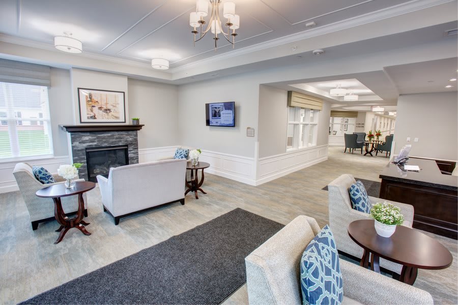 A modern living room with elegant furnishings, featuring a fireplace, television, and comfortable sofas.
