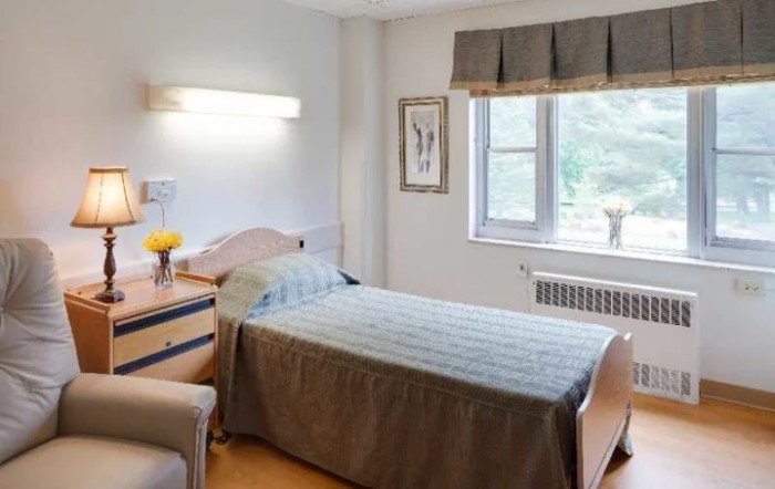 A hospital room with a single bed and decor.