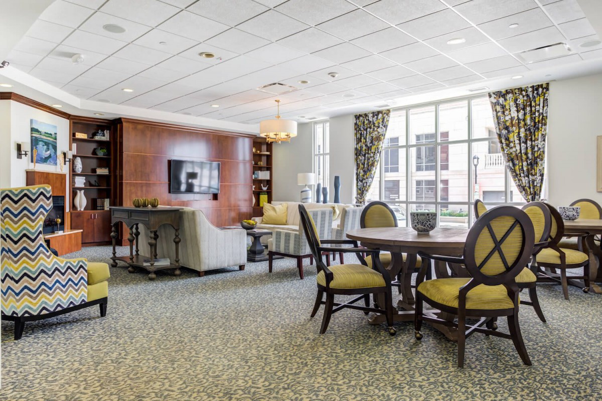 A modern living room with comfortable seating, a television, and a dining area.