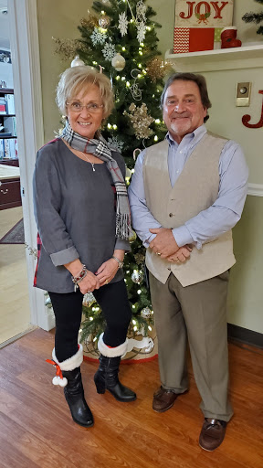 A cheerful moment celebrating the holiday season in front of a beautifully decorated Christmas tree.