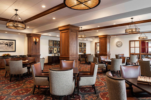 A cozy lounge area featuring elegant furniture and warm lighting.