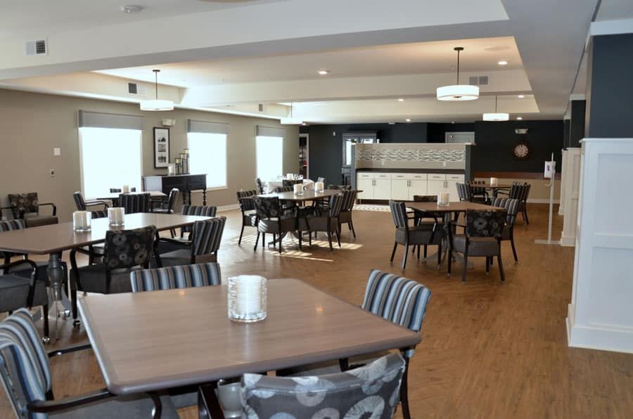 A spacious dining area with tables and chairs, featuring modern interior design and ample lighting.