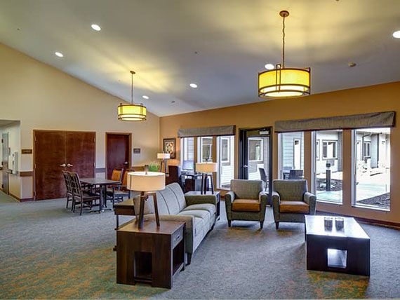 A spacious and modern living room with comfortable seating and stylish lighting.