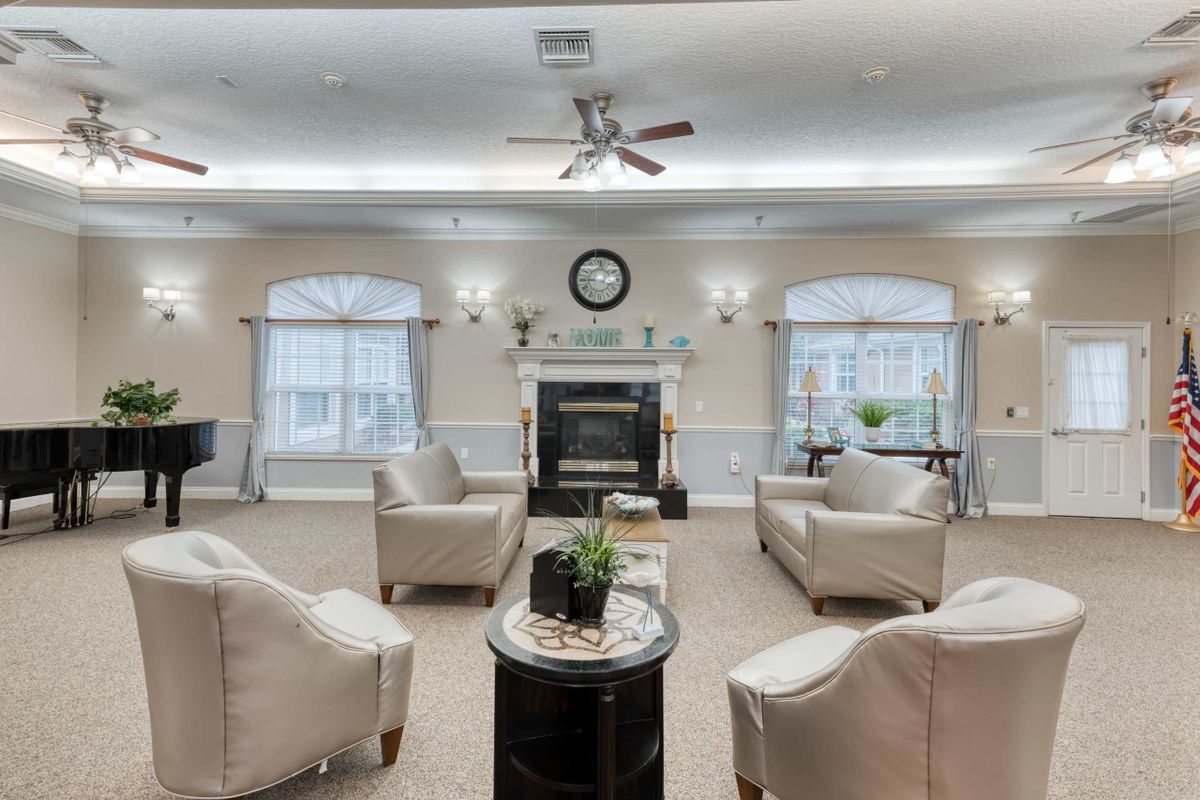 A cozy living room with stylish chairs and a central fireplace.