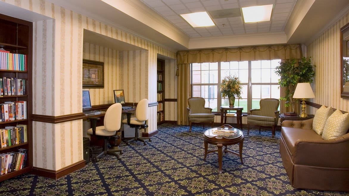 An elegantly designed lobby with a seating area and computer workstations.