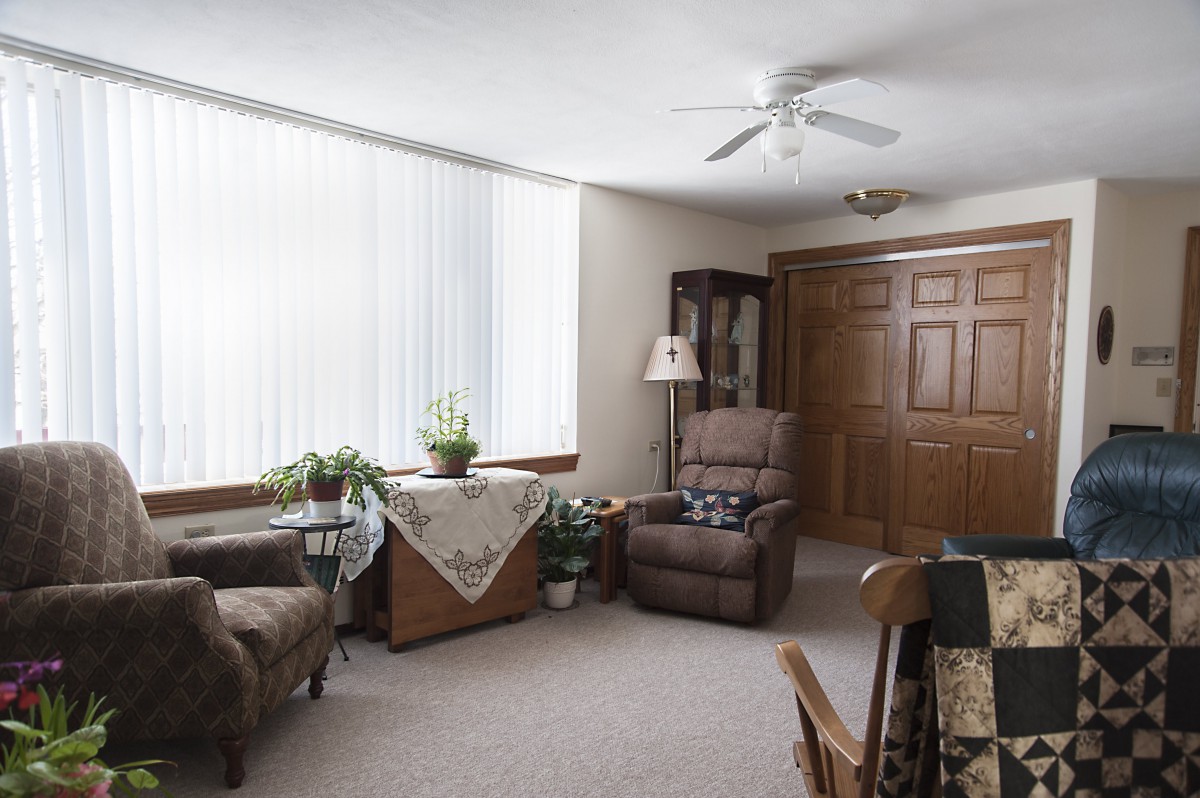 A cozy living room with comfortable seating and indoor plants.