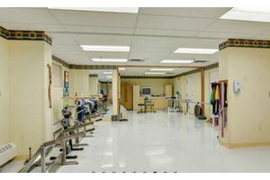 An indoor gym with exercise equipment and workout space.