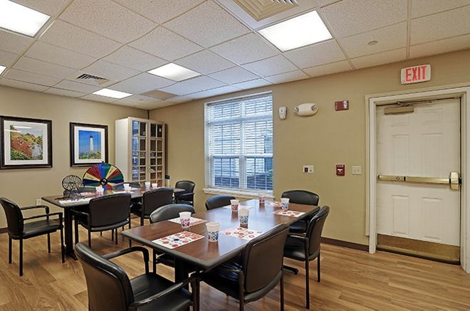 A well-lit conference room with a meeting table and chairs.