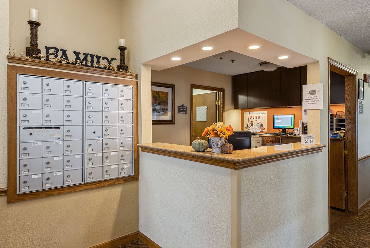 A welcoming reception area with mailboxes and a decorated front desk.