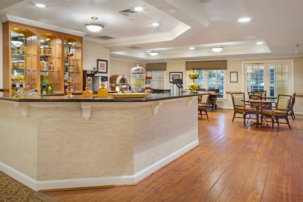A cozy cafe interior with a central counter and seating area.