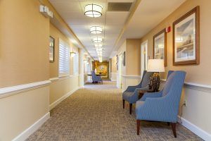 A well-lit hallway with comfortable chairs and decorative artwork.