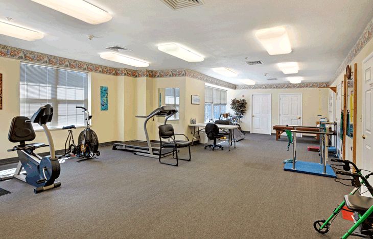 A fitness room equipped with exercise machines including treadmills and stationary bikes.