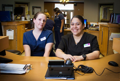 Healthcare professionals posing for a photo in their workspace.
