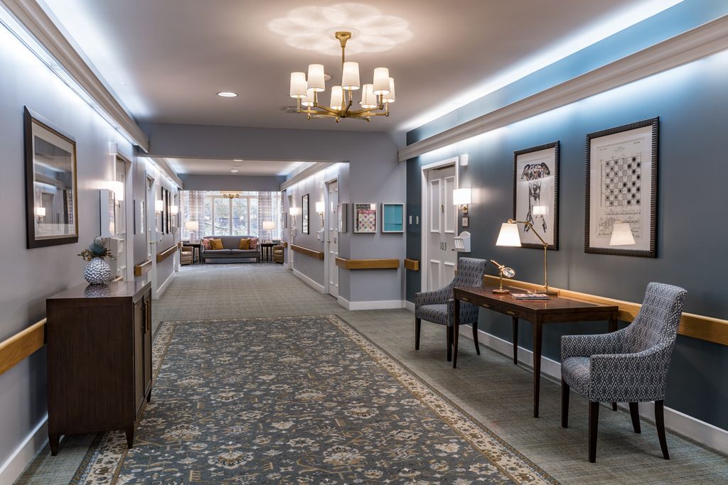 A well-lit hallway with elegant decor and comfortable seating.