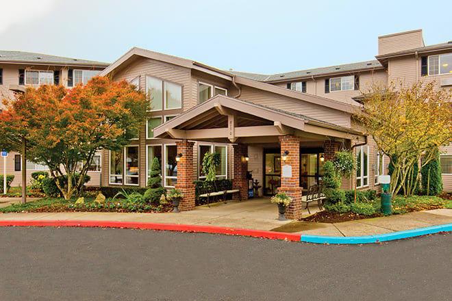 A modern building entrance with landscaped surroundings.