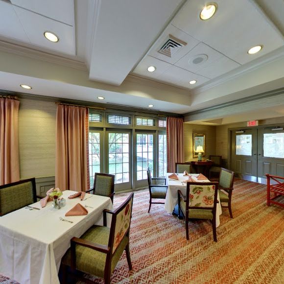 A cozy dining room with set tables and comfortable seating.