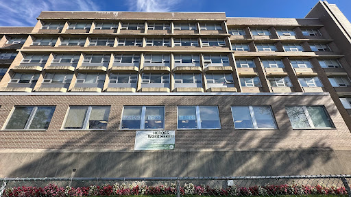 A modern building featuring multiple windows and a simple architectural design.