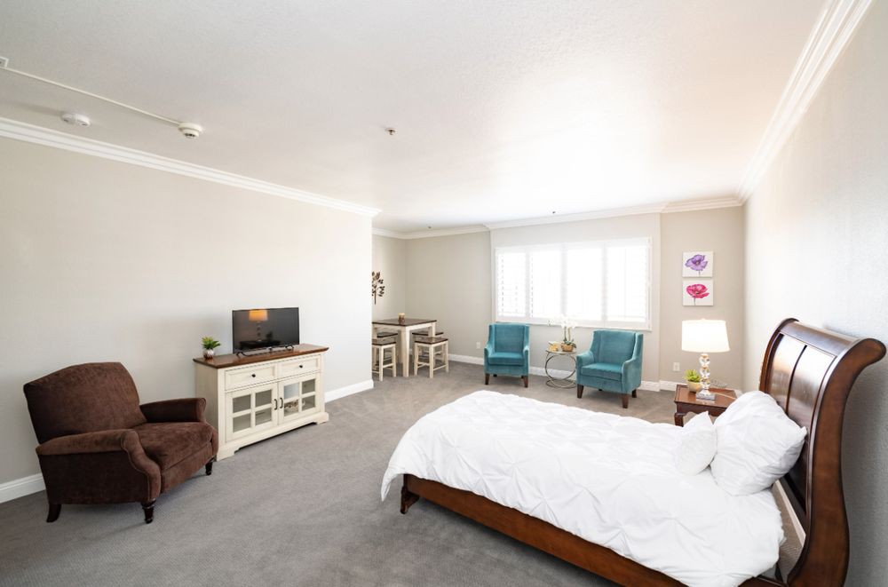 A spacious and modern bedroom with bright lighting and minimalist decor.