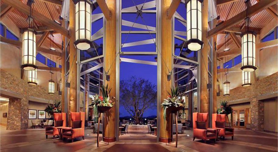 A luxurious, modern interior with symmetrical design elements and elegant lighting against a twilight backdrop.