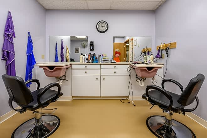 An interior view of a hair salon with two styling stations and mirrors.