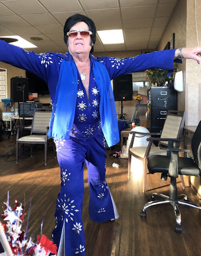 A vibrant performer in a dazzling blue costume showcasing their talent.
