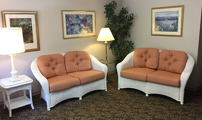 An inviting waiting room with two cozy sofas and warm lighting.