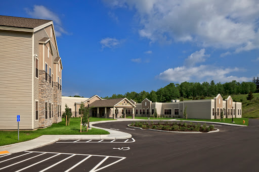 A modern residential facility with a well-designed exterior and a clear blue sky.
