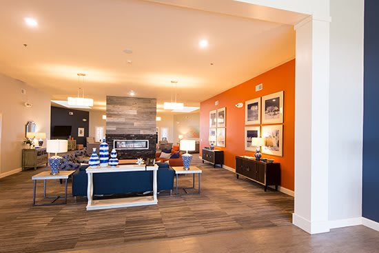 A modern lobby area with vibrant orange accents and contemporary furniture.