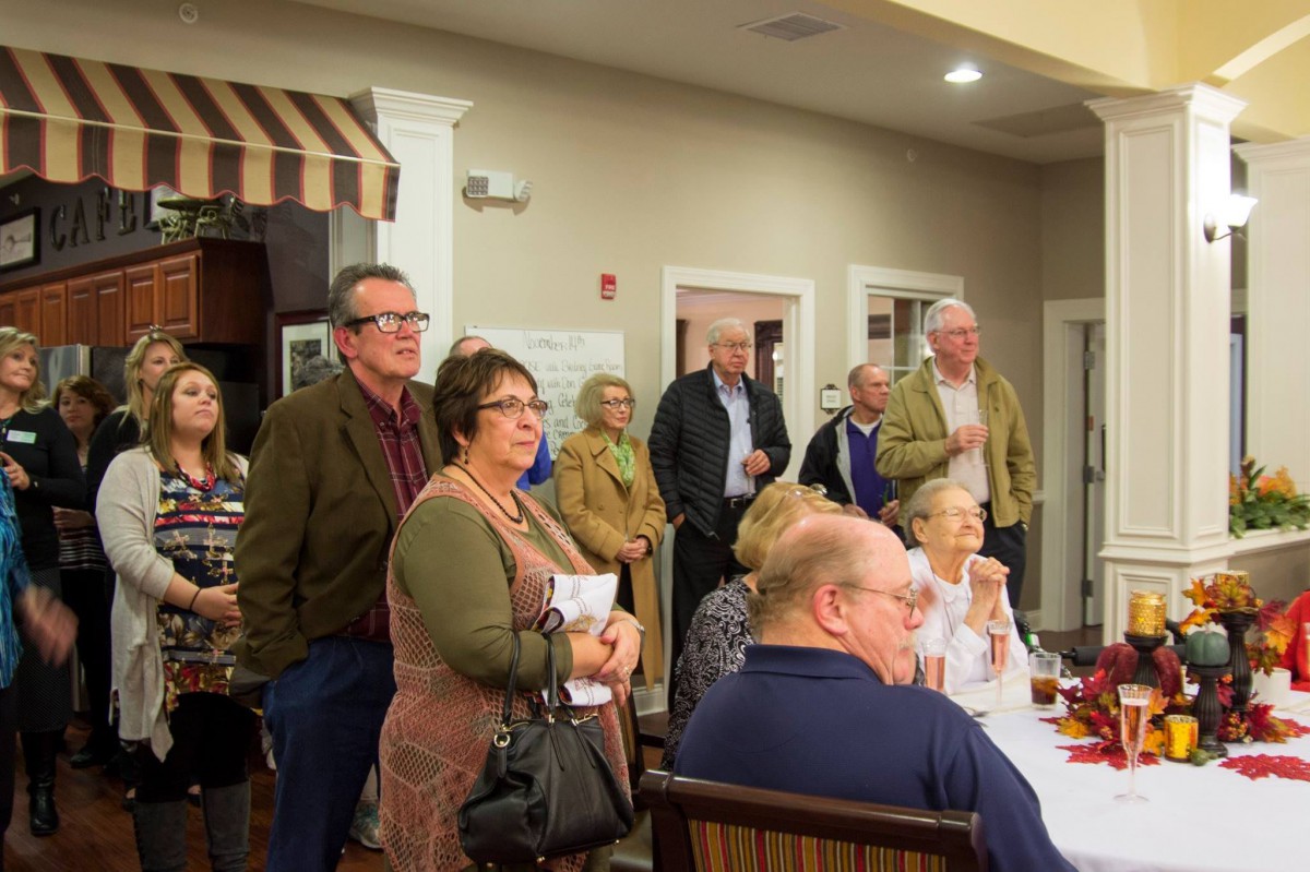 A group of people gathered indoors for a community meeting.