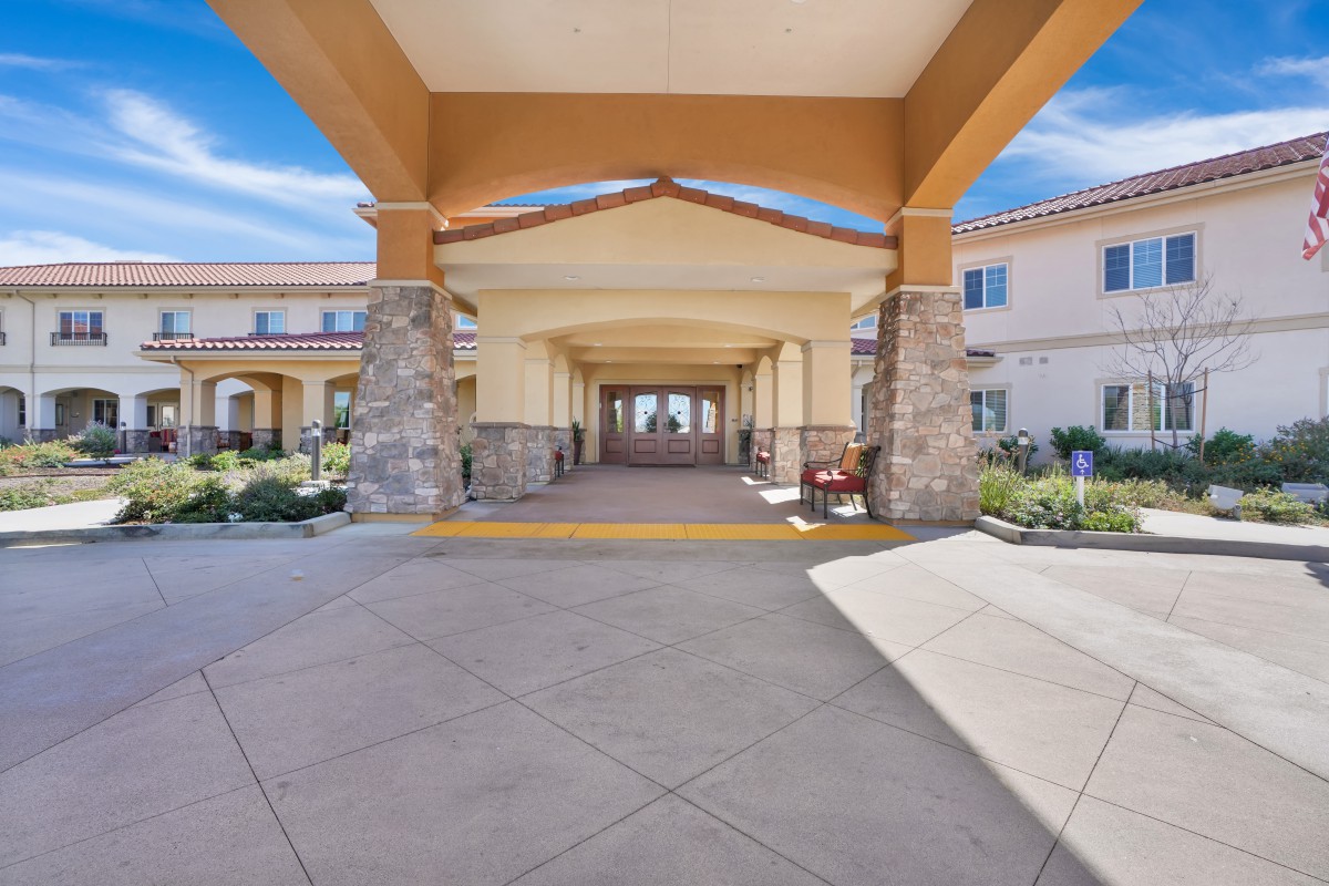 A welcoming entrance with a covered walkway and landscaped surroundings.