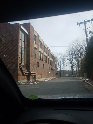 A view of a brick building along a quiet street.